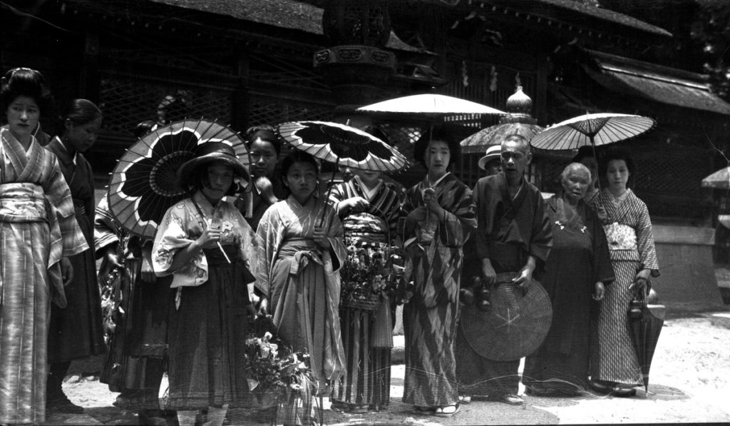 Group of women in kimonos, carrying parasols. Stop at the Buddhist temple. Two days entertainment in home of Mr. G. Tsukamoto. © The Field Museum, CSA50298
